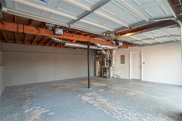 garage with a garage door opener, gas water heater, heating unit, and electric panel