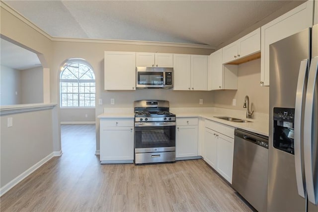 kitchen featuring appliances with stainless steel finishes, sink, and white cabinets