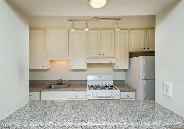 kitchen with sink, cream cabinets, white appliances, and light stone countertops