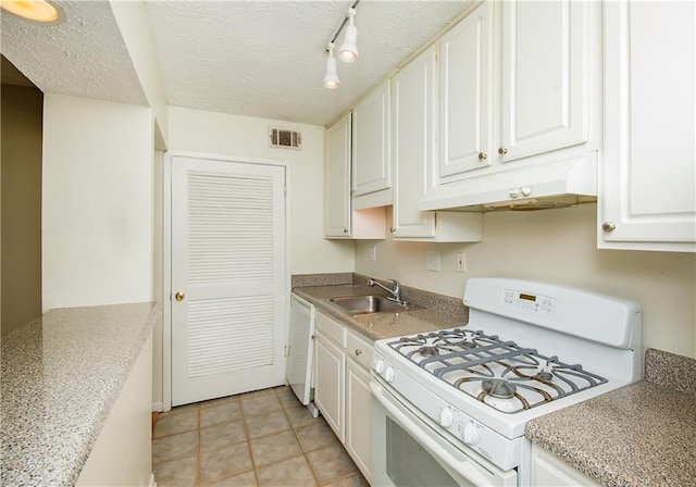 kitchen featuring sink, white cabinets, light tile patterned floors, white appliances, and rail lighting