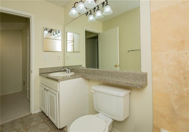 bathroom with tile patterned floors, toilet, and vanity