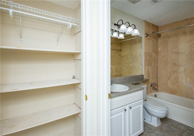 full bathroom featuring tiled shower / bath combo, toilet, tile patterned flooring, and vanity