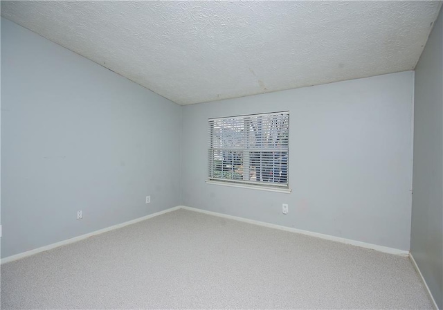 unfurnished room featuring a textured ceiling and carpet floors