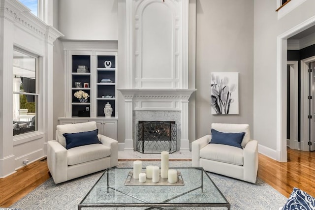 living room featuring a premium fireplace and wood-type flooring