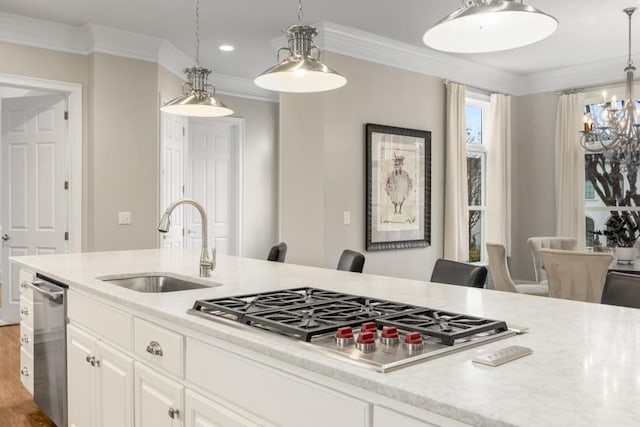 kitchen featuring white cabinetry, sink, decorative light fixtures, and stainless steel appliances