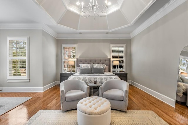 bedroom featuring hardwood / wood-style flooring, crown molding, and a chandelier