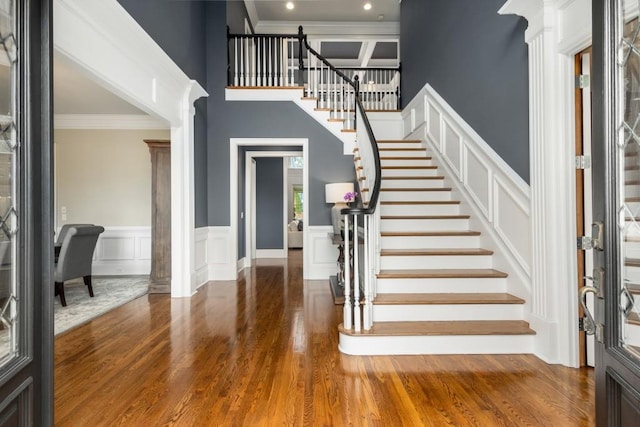 entrance foyer with hardwood / wood-style floors and ornamental molding