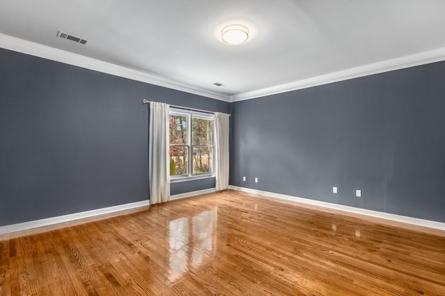 unfurnished room featuring crown molding and wood-type flooring