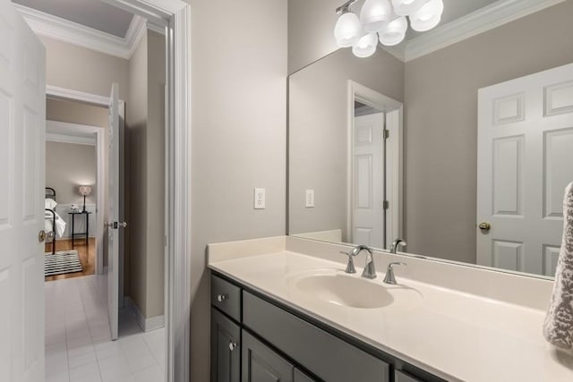 bathroom featuring crown molding, vanity, and tile patterned floors