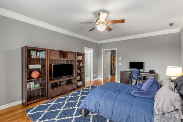 bedroom featuring ornamental molding, hardwood / wood-style floors, and ceiling fan