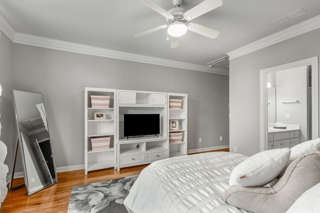 bedroom featuring ornamental molding, ensuite bathroom, ceiling fan, and light hardwood / wood-style flooring