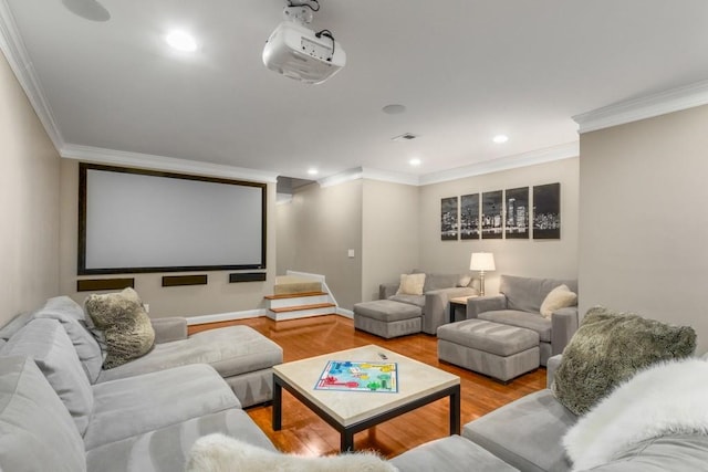 cinema with ornamental molding and light hardwood / wood-style floors