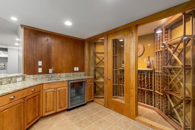 wine cellar featuring light tile patterned floors, beverage cooler, and indoor wet bar