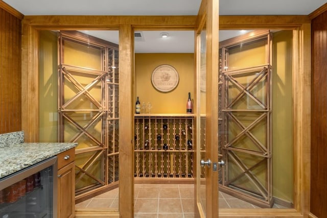 wine area featuring light tile patterned flooring and beverage cooler