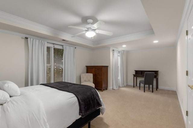 bedroom with light carpet, a tray ceiling, crown molding, and ceiling fan