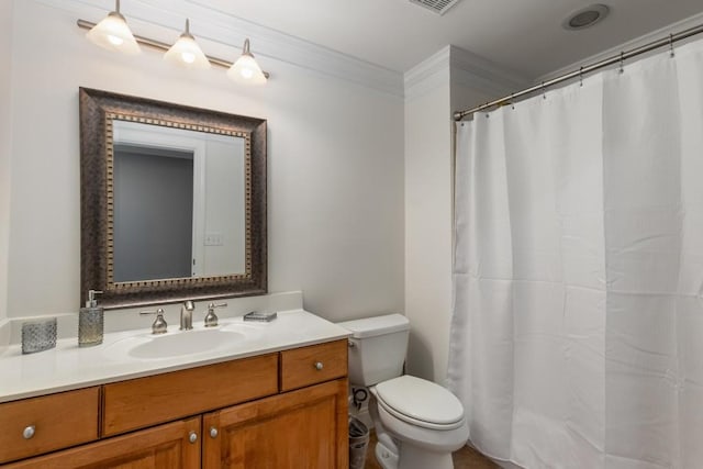 bathroom featuring vanity, ornamental molding, and toilet