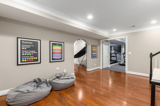 interior space with ornamental molding and hardwood / wood-style floors