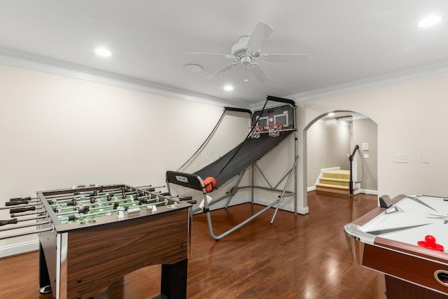 rec room featuring crown molding, ceiling fan, and dark hardwood / wood-style flooring