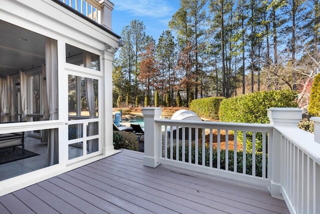 wooden deck featuring a sunroom