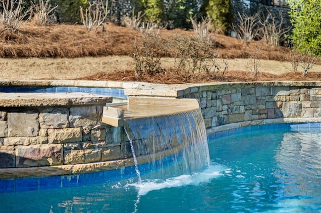 view of pool featuring pool water feature