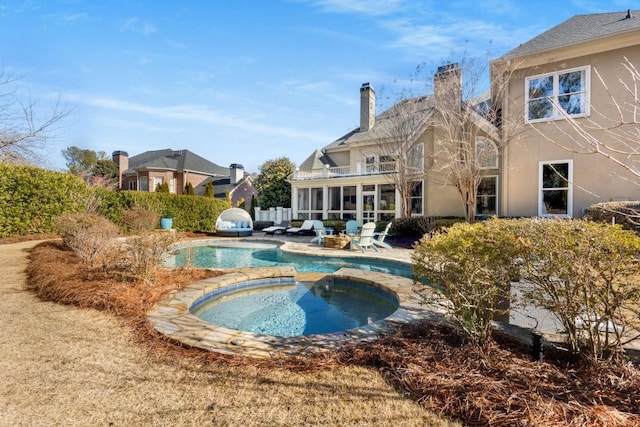 view of pool featuring an in ground hot tub