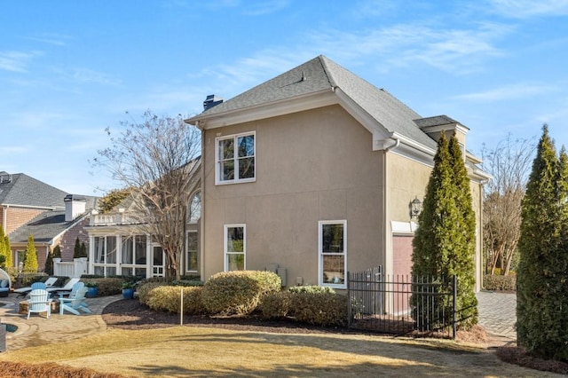 view of property exterior with a patio area