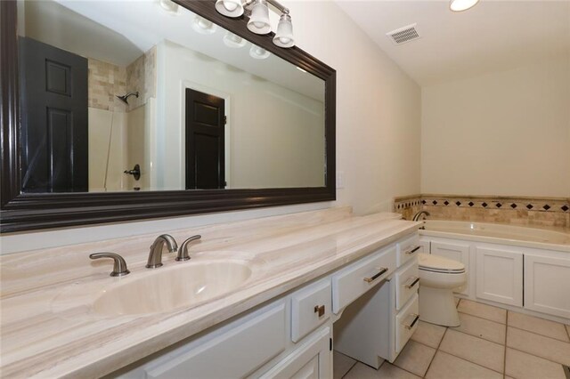 bathroom with a bathtub, vanity, tile patterned flooring, and toilet