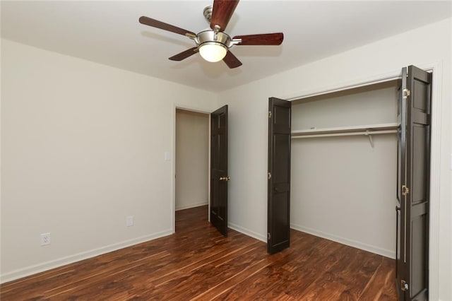 unfurnished bedroom featuring ceiling fan, dark hardwood / wood-style floors, and a closet