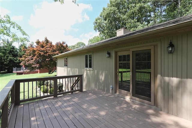 wooden terrace featuring a yard