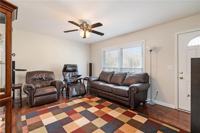 living room featuring ceiling fan and dark hardwood / wood-style flooring