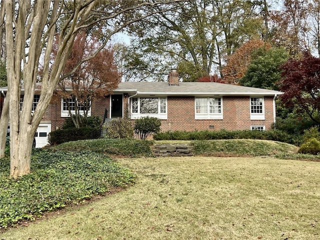 ranch-style house featuring brick siding, a chimney, and a front yard