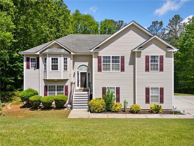 raised ranch with a front lawn