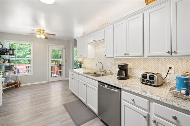 kitchen with stainless steel dishwasher, a sink, tasteful backsplash, and ceiling fan