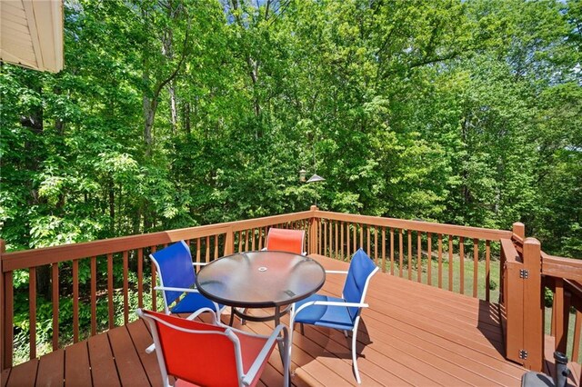 wooden terrace with outdoor dining space