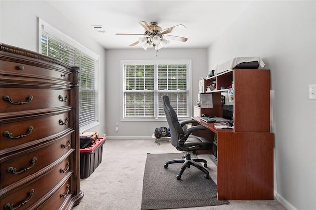 office area featuring light colored carpet, a ceiling fan, and baseboards