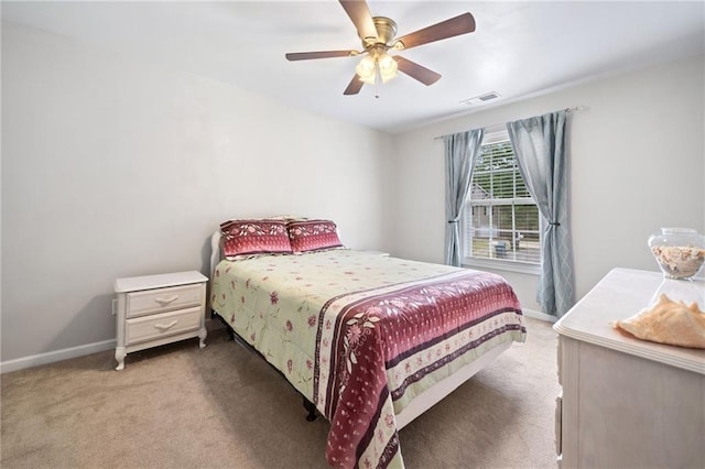 carpeted bedroom featuring baseboards and a ceiling fan