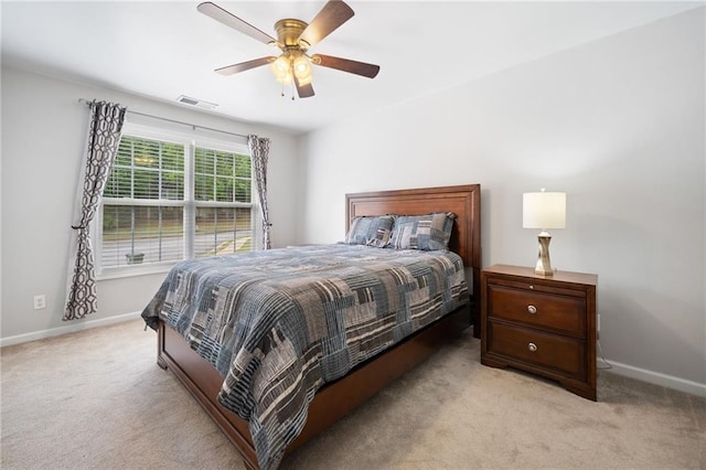 bedroom featuring light colored carpet, baseboards, and ceiling fan