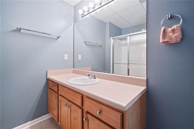bathroom featuring a shower stall, vanity, and tile patterned flooring