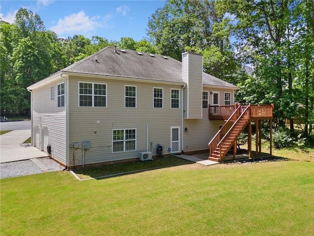 back of property featuring a wooden deck, stairway, a chimney, and a yard