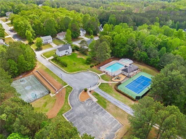 bird's eye view of a forest and a pool area
