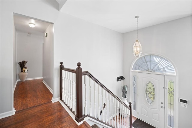 entryway with wood finished floors and baseboards