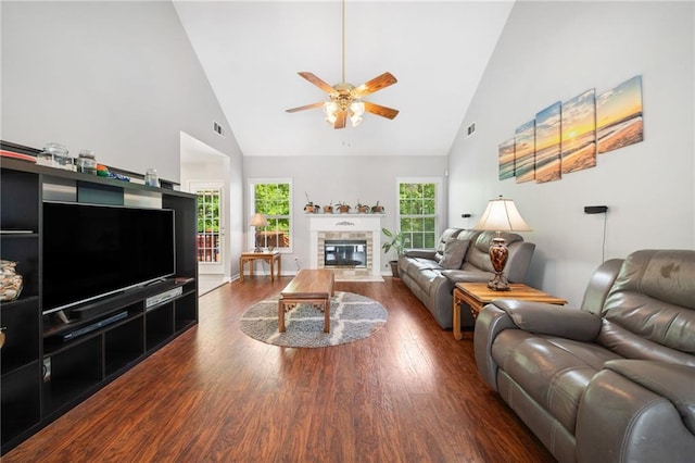 living room featuring high vaulted ceiling, a ceiling fan, wood finished floors, and a fireplace