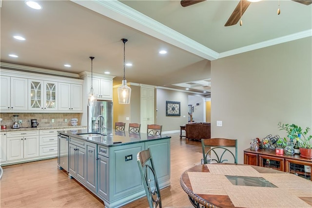8240 Hurakan Creek Xing, Cumming, GA 30028 - kitchen with a sink, ornamental molding, white cabinets, light wood-style flooring, and a ceiling fan