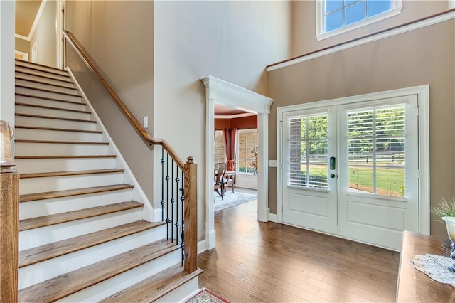 8240 Hurakan Creek Xing, Cumming, GA 30028 - entrance foyer with french doors, a high ceiling, stairs, and wood finished floors