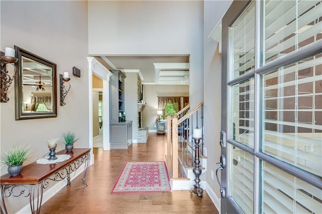 8240 Hurakan Creek Xing, Cumming, GA 30028 - entryway featuring wood finished floors, stairway, a towering ceiling, and baseboards