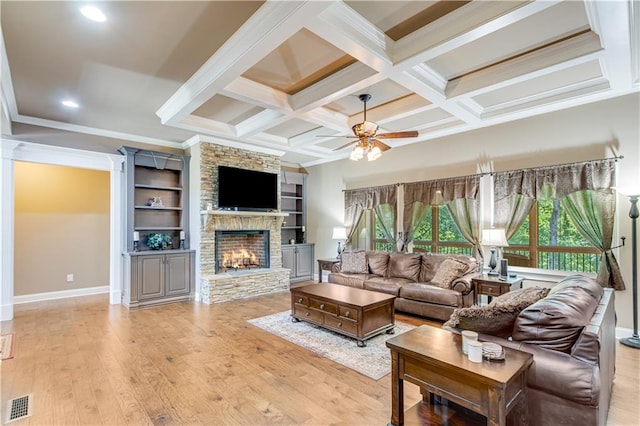 8240 Hurakan Creek Xing, Cumming, GA 30028 - living area featuring a stone fireplace, a ceiling fan, baseboards, coffered ceiling, and light wood-style floors