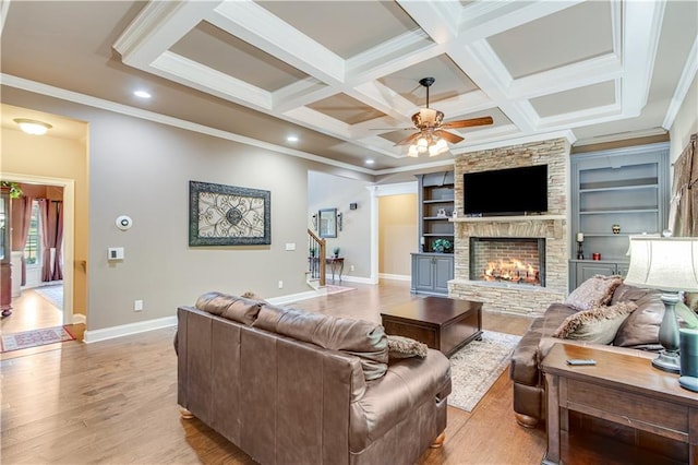8240 Hurakan Creek Xing, Cumming, GA 30028 - living area with light wood-style flooring, a ceiling fan, baseboards, a fireplace, and ornamental molding