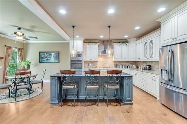 8240 Hurakan Creek Xing, Cumming, GA 30028 - kitchen with appliances with stainless steel finishes, wall chimney exhaust hood, white cabinets, ornamental molding, and recessed lighting