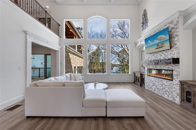 living room with plenty of natural light, visible vents, and wood finished floors