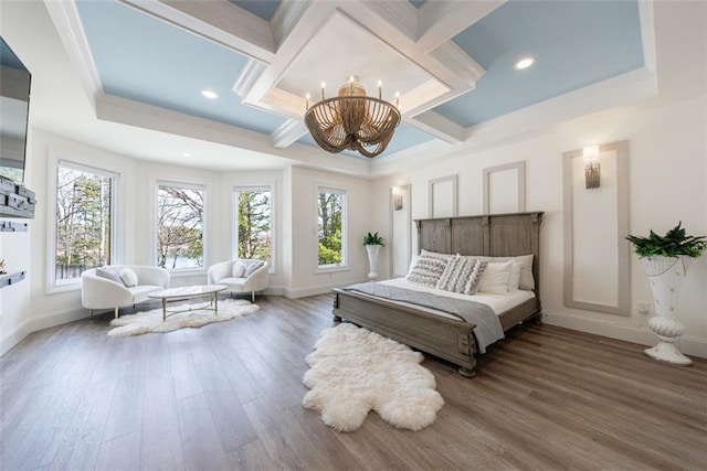 bedroom featuring an inviting chandelier, baseboards, coffered ceiling, and wood finished floors